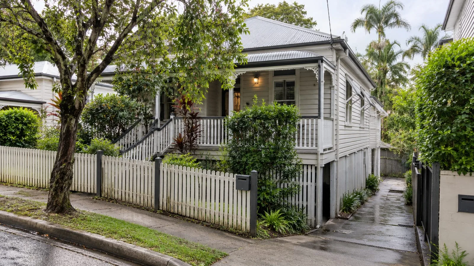 AI-generated illustration: Paddington hilly residential street, raised weatherboard Queenslander with veranda and a narrow wet concrete side path and drain