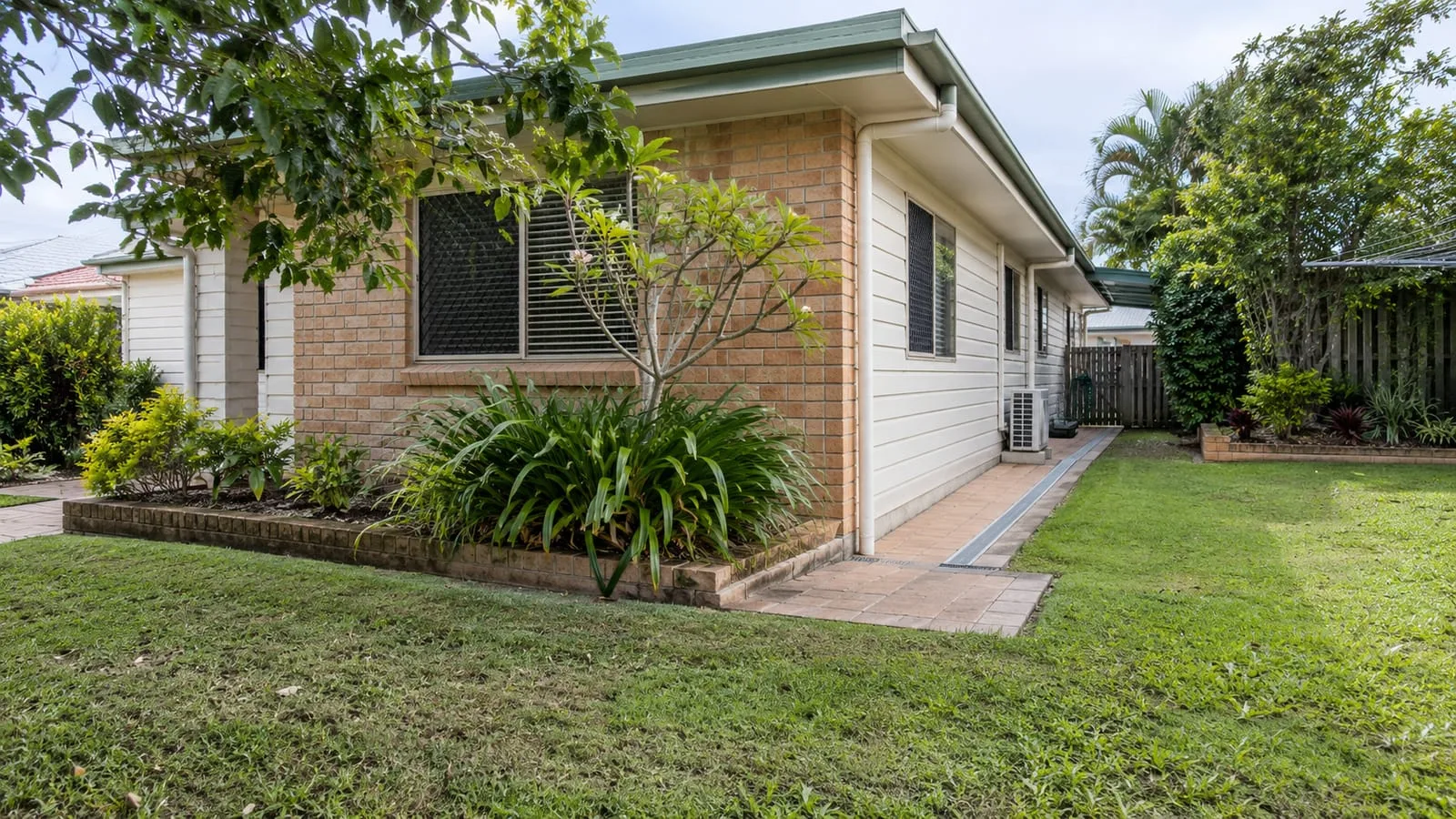 AI-generated illustration: Aspley suburban home and weatherboard and brick garden with understated paved drainage